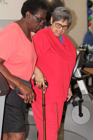 Nurse assisting patient with post physical therapy.