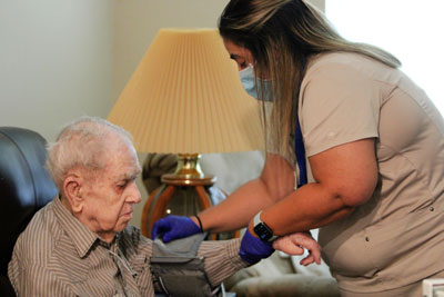 Female nurse assisting elderly patient.