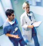 Photo of two nurses speaking to one another